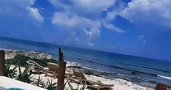 The private beach area with loungers on the east shore